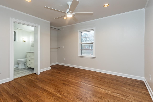 unfurnished bedroom with baseboards, crown molding, and wood finished floors