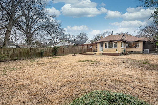 view of yard with central AC unit and fence