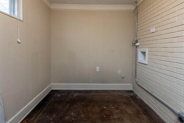 unfurnished room with concrete flooring, ornamental molding, and baseboards