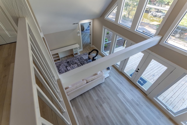 interior space with lofted ceiling, visible vents, and wood finished floors