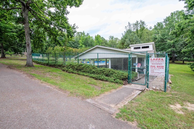 view of front of house featuring a front yard, fence, and a gate