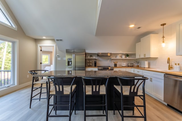 kitchen featuring stainless steel appliances, open shelves, visible vents, and white cabinets