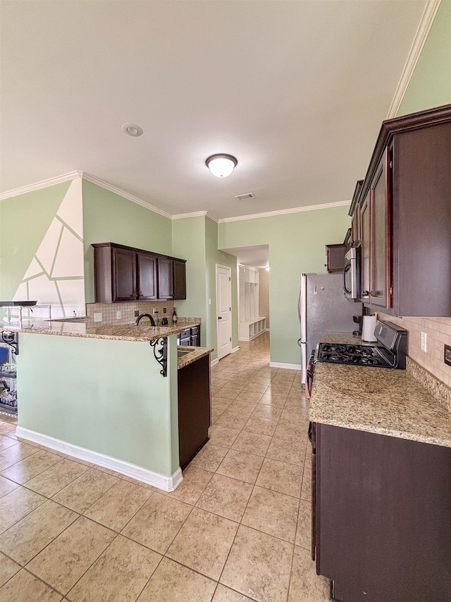 kitchen with dark brown cabinetry, light tile patterned floors, visible vents, ornamental molding, and stainless steel appliances