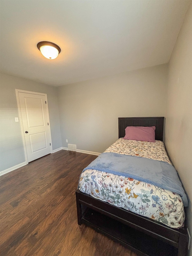 bedroom featuring dark wood-style floors, visible vents, and baseboards