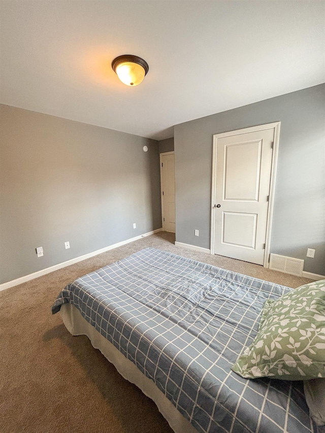 bedroom with carpet, visible vents, and baseboards