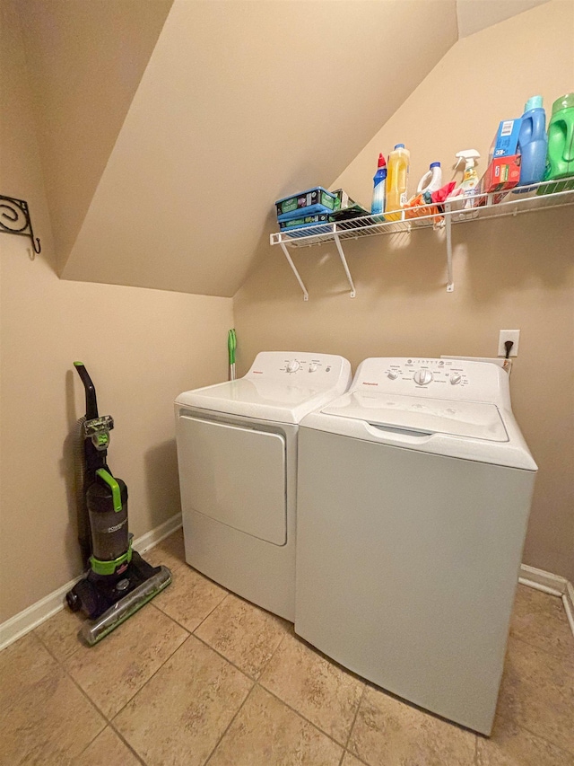 laundry room with laundry area, baseboards, and washer and clothes dryer