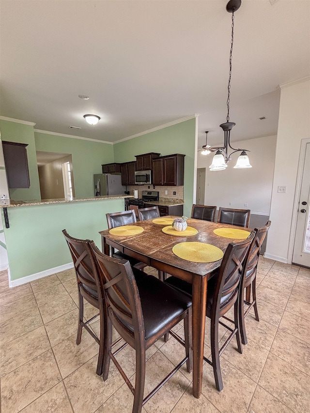 dining room with baseboards and crown molding