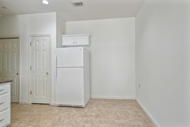 interior space with baseboards and visible vents