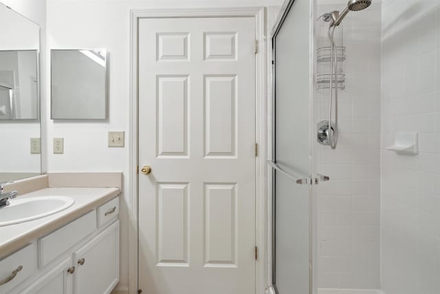 full bathroom featuring a shower stall and vanity