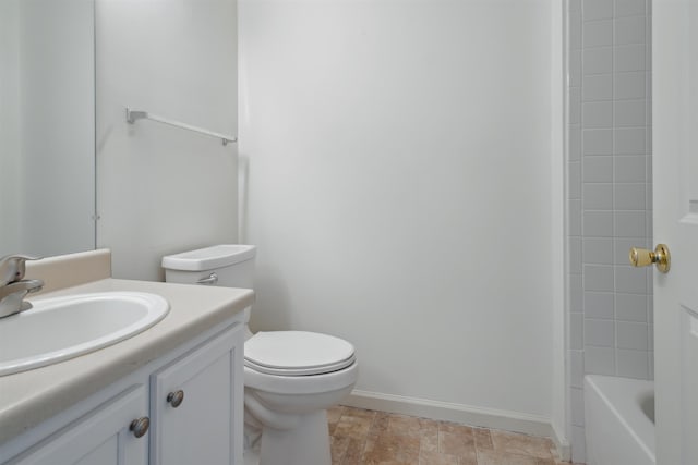 full bath featuring vanity, toilet, and baseboards