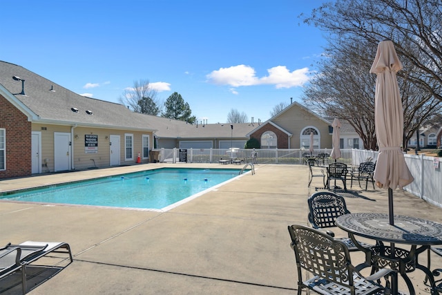 community pool featuring a patio area and fence