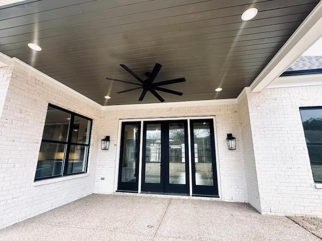 entrance to property with a patio area and ceiling fan