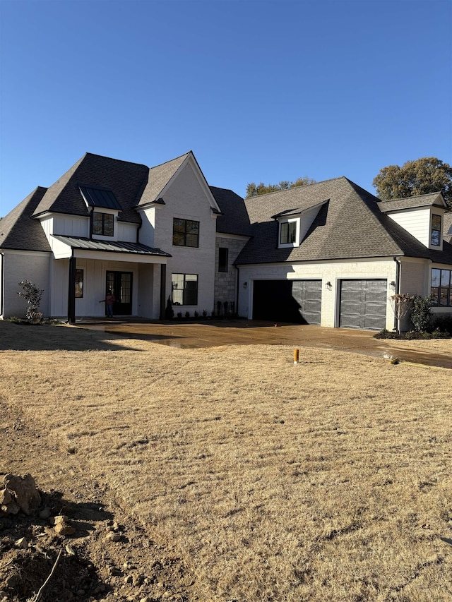 modern farmhouse with metal roof, a porch, a shingled roof, and a standing seam roof