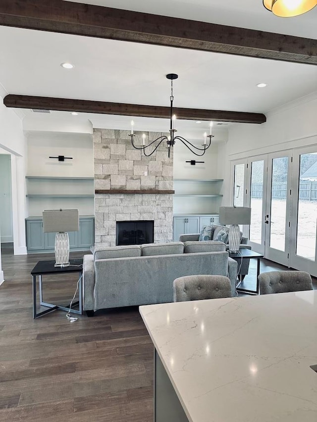 living room with a stone fireplace, dark wood-type flooring, and beamed ceiling