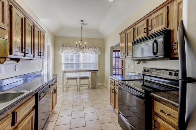 kitchen with a chandelier, brown cabinets, black appliances, dark countertops, and pendant lighting