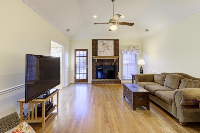 living area featuring ornamental molding, light wood finished floors, and a healthy amount of sunlight