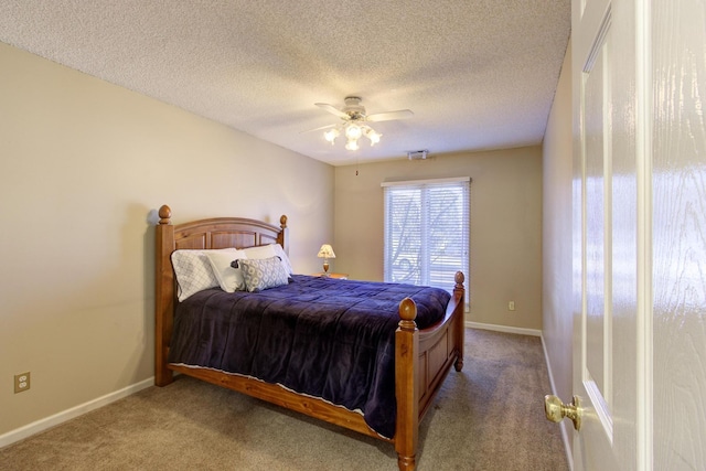 carpeted bedroom featuring ceiling fan, baseboards, and a textured ceiling