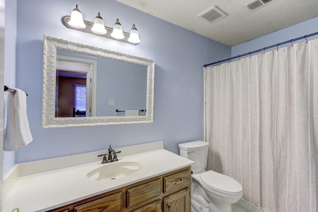 bathroom with visible vents, a textured ceiling, toilet, and vanity