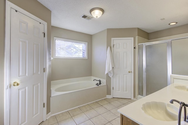 full bathroom with a garden tub, visible vents, a stall shower, a sink, and tile patterned flooring