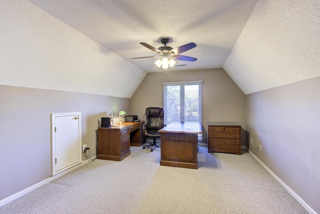 office featuring ceiling fan, carpet floors, visible vents, baseboards, and vaulted ceiling