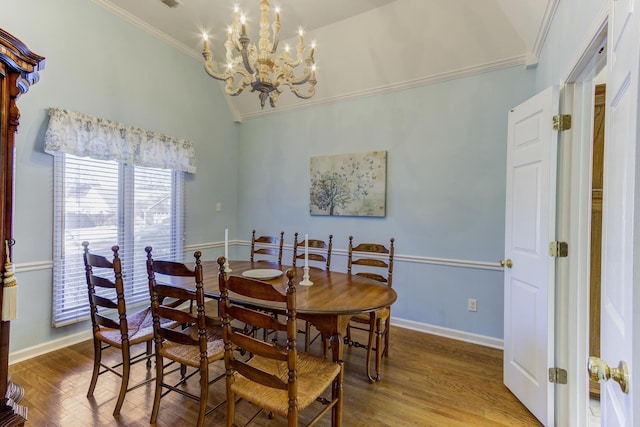 dining area featuring ornamental molding, wood finished floors, and baseboards