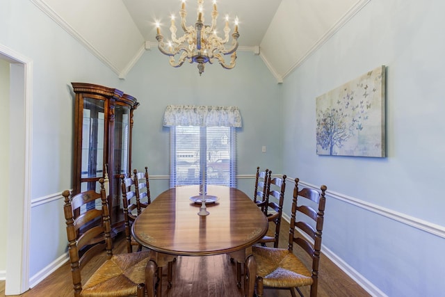 dining space with baseboards, wood finished floors, vaulted ceiling, crown molding, and a chandelier