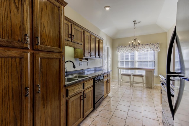 kitchen with dishwasher, dark countertops, freestanding refrigerator, an inviting chandelier, and a sink