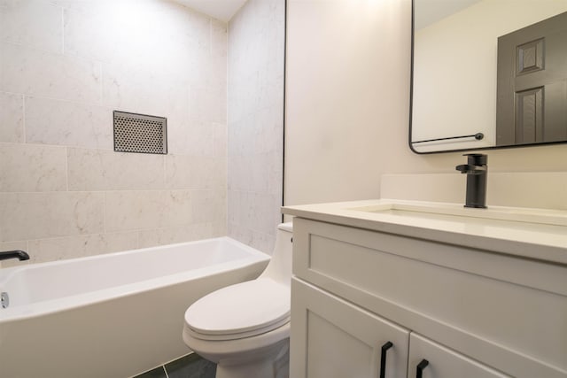 bathroom featuring washtub / shower combination, vanity, and toilet