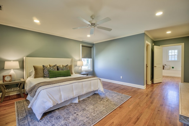 bedroom featuring crown molding, baseboards, wood finished floors, and recessed lighting