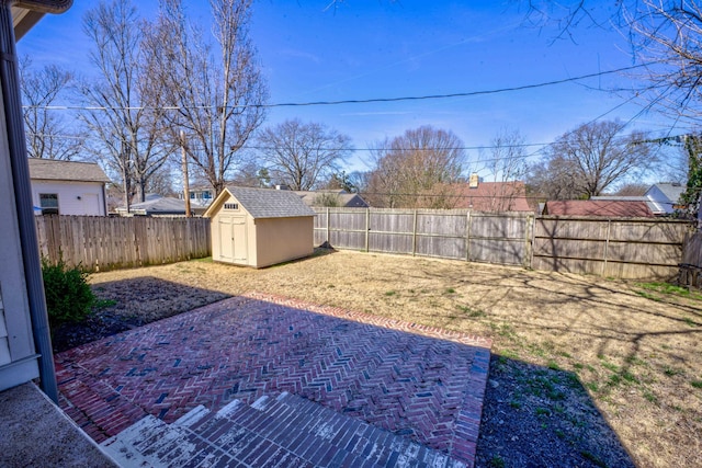 view of yard featuring a shed, a patio, a fenced backyard, and an outdoor structure