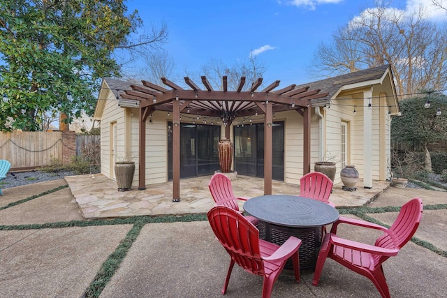 view of patio / terrace featuring fence, a pergola, and outdoor dining space