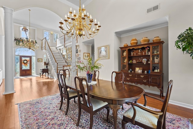 dining area with visible vents, hardwood / wood-style floors, and ornate columns