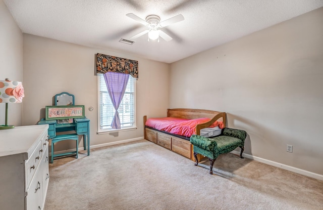 bedroom featuring baseboards, visible vents, and light colored carpet