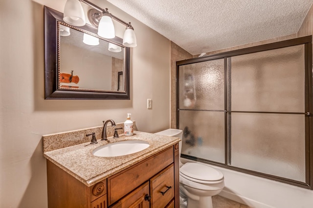 full bath with toilet, combined bath / shower with glass door, a textured ceiling, and vanity