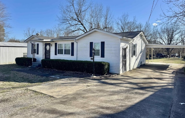 view of front of house featuring an attached carport and concrete driveway