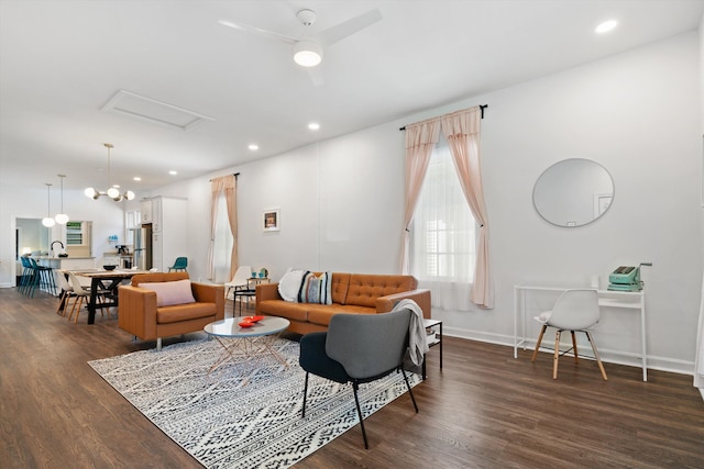 living room with baseboards, dark wood-type flooring, and recessed lighting