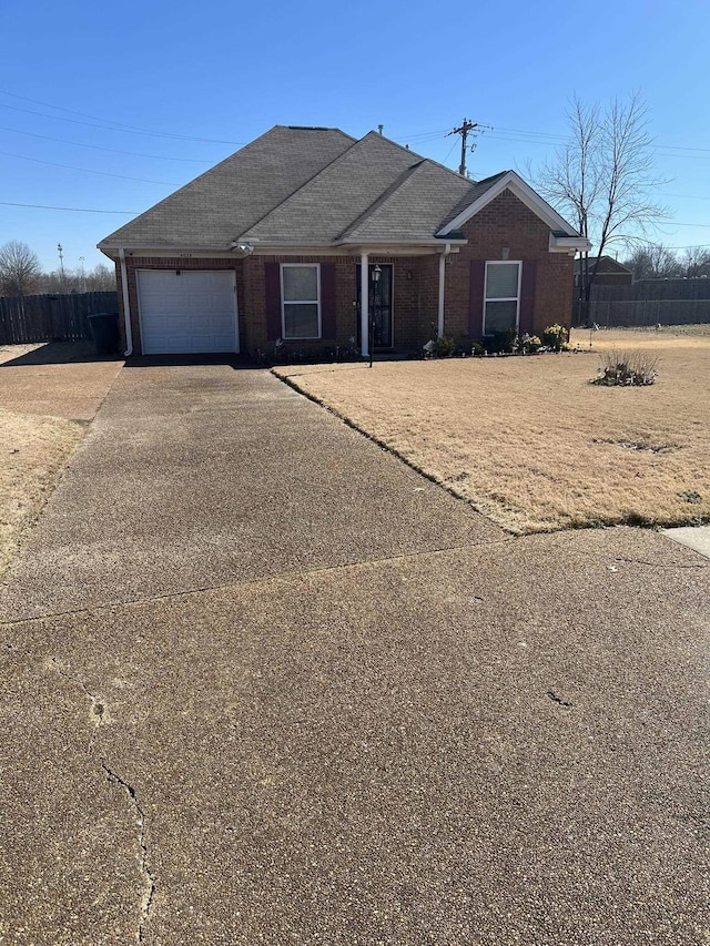 ranch-style home featuring driveway, an attached garage, a shingled roof, and brick siding