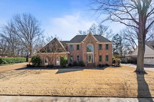 view of front of house featuring fence and brick siding