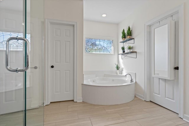 full bathroom with a garden tub