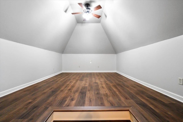 bonus room with vaulted ceiling, ceiling fan, dark wood-style floors, and baseboards