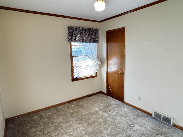 empty room with baseboards, visible vents, and carpet flooring