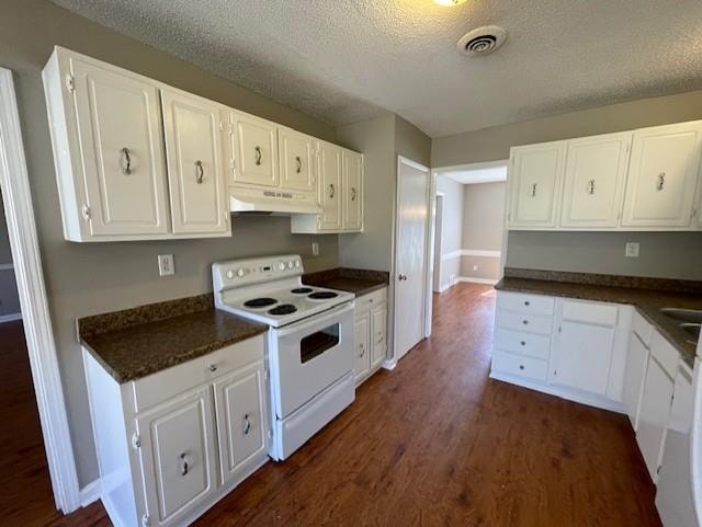 kitchen featuring under cabinet range hood, white electric range, dark wood-type flooring, white cabinets, and dark countertops