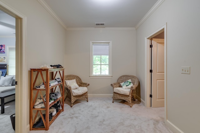 sitting room with carpet, visible vents, ornamental molding, and baseboards