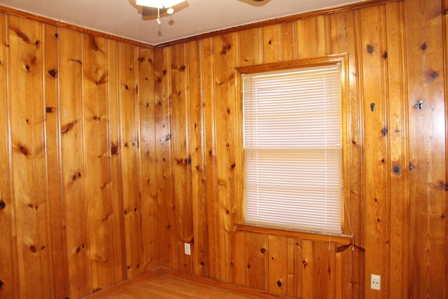 spare room with wooden walls and wood finished floors