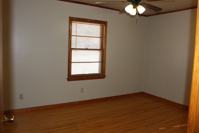 unfurnished room featuring a ceiling fan, baseboards, wood finished floors, and ornamental molding