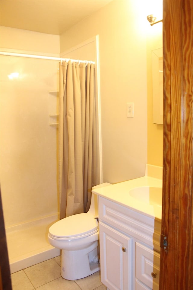 full bathroom with toilet, a shower stall, vanity, and tile patterned floors