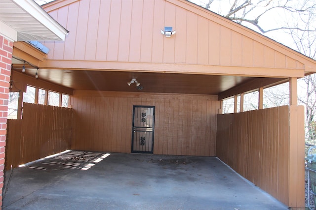 exterior space featuring a carport and fence