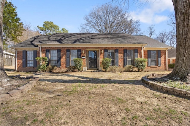 single story home featuring brick siding