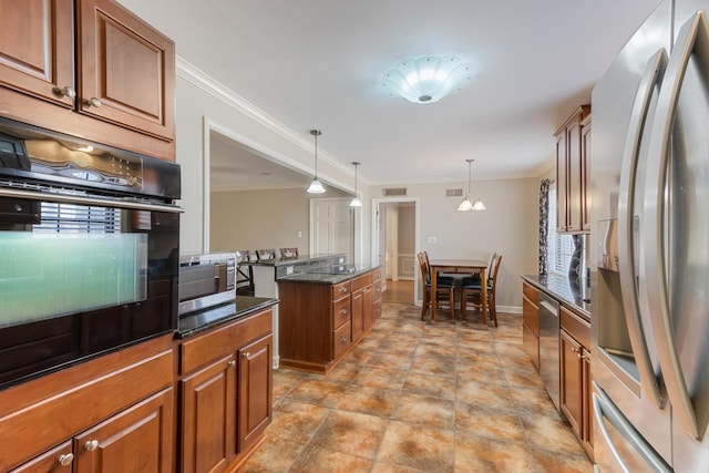 kitchen featuring appliances with stainless steel finishes, pendant lighting, brown cabinetry, and crown molding