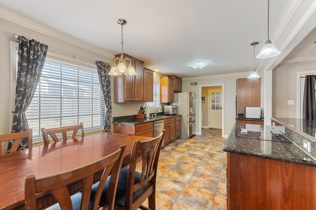 kitchen featuring brown cabinets, a sink, stainless steel appliances, crown molding, and a wealth of natural light